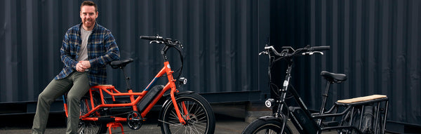 A photo of Mike Radenbaugh seated on a RadWagon next to another RadWagon.