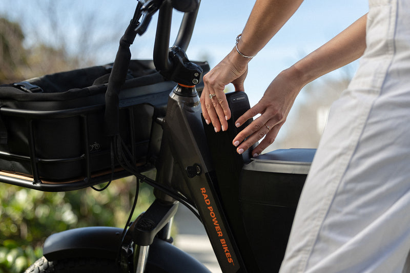 Person removing the ebike battery on a bike with a locking console installed.