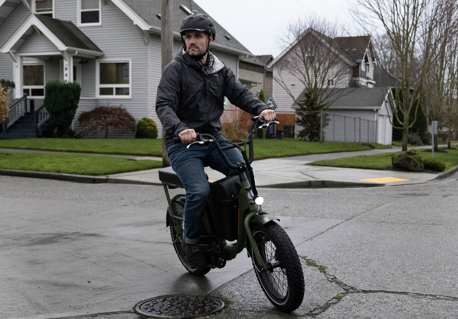 A man rides a fat tire ebike in the rain.
