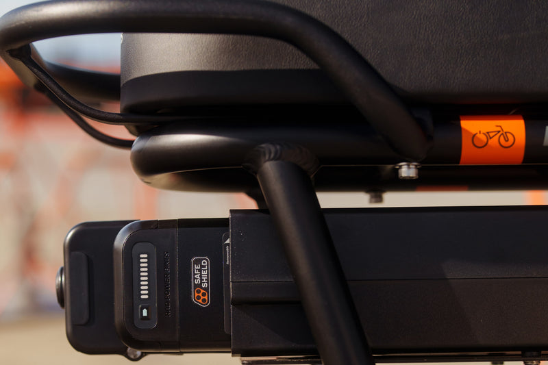 A close up of a range extender with a Safe Shield battery in it. 