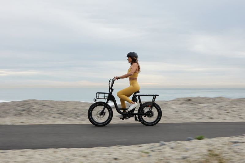 Riding a black RadRunner in front of the beach