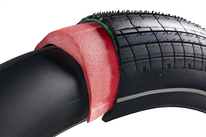 Bike tire with part cut away to show a Tannus liner and tube