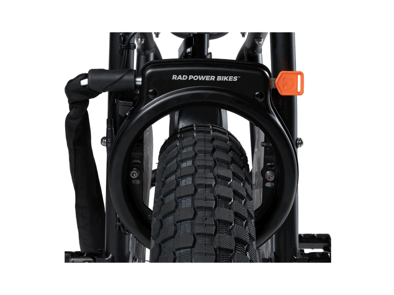 Rad Fat Tire Wheel Lock installed on an ebike, showing the orange key and with the optional security chain attached.